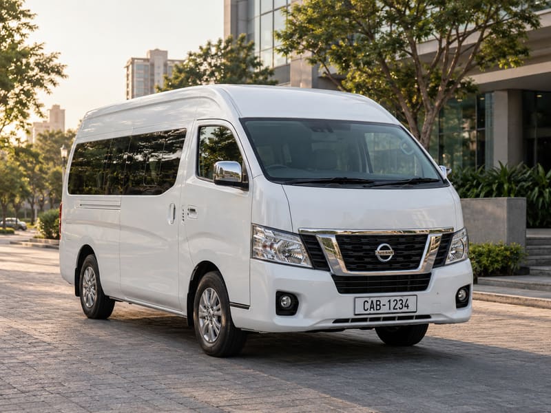 White Nissan Caravan high-roof van parked on a paved forecourt in Colombo.